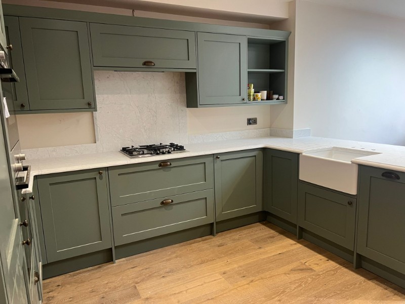 Green kitchen with white worktop