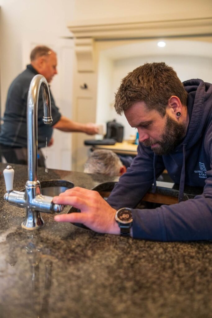 The surrey marble and granite team installing a worktop