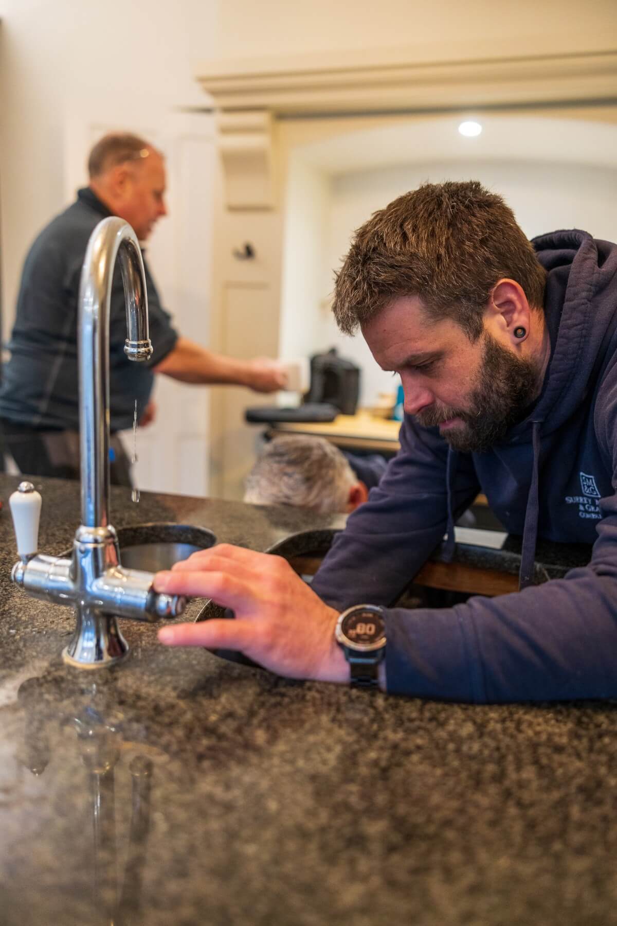 The surrey marble and granite team installing a worktop